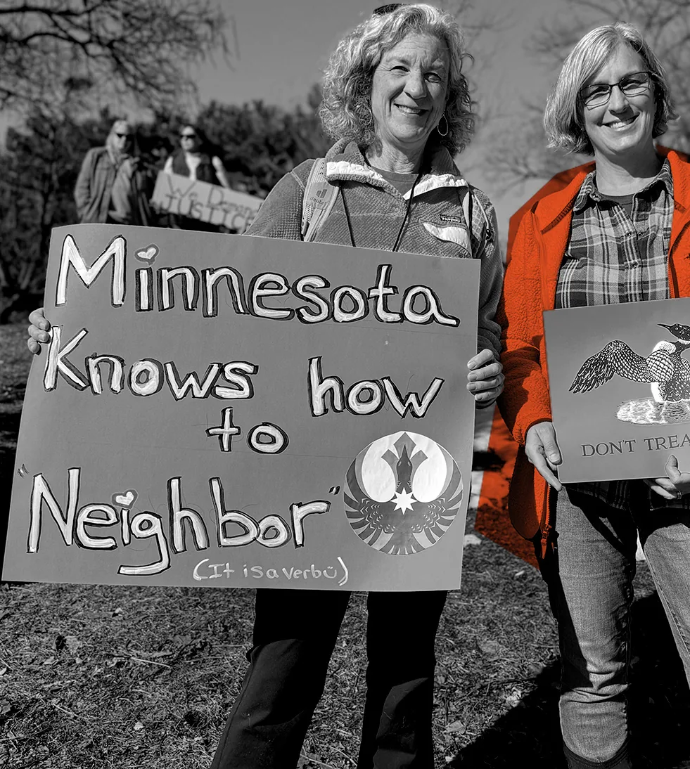 Minnesotans rally with 'Minnesota Knows How to Neighbor (It is a verb)' sign